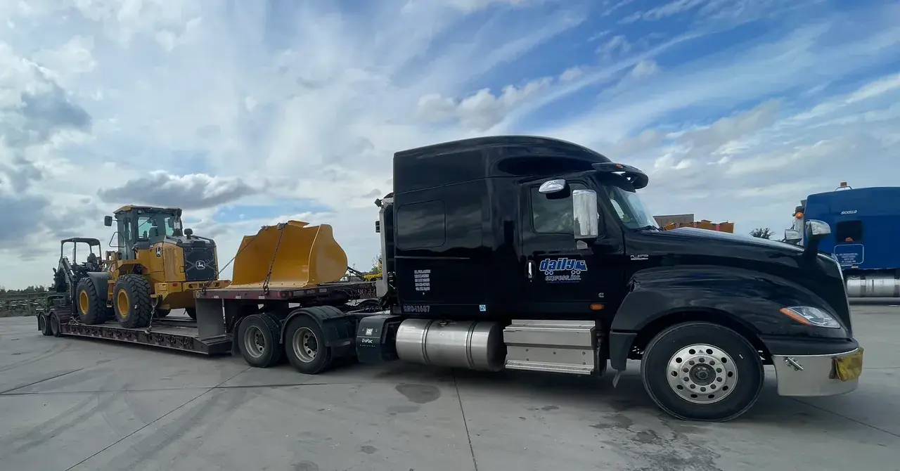 a loaded John Deere front loader shows how Daily earned the Achieving Excellence Award